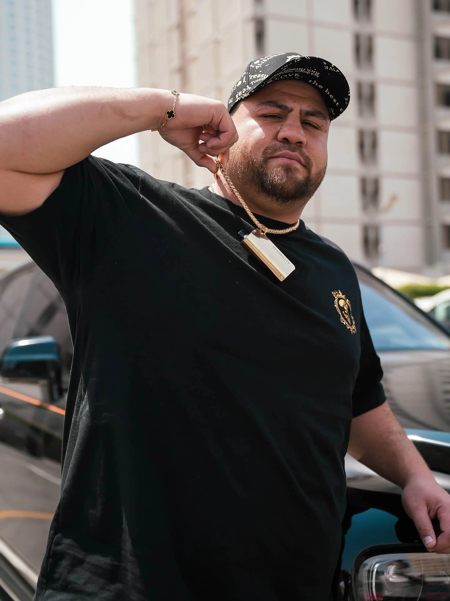 Adult ALIBARBAR lifestyle portrait featuring a gold device and premium urban styling
